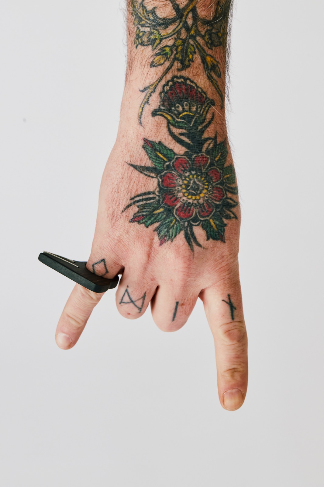 Black wing ring worn between fingers