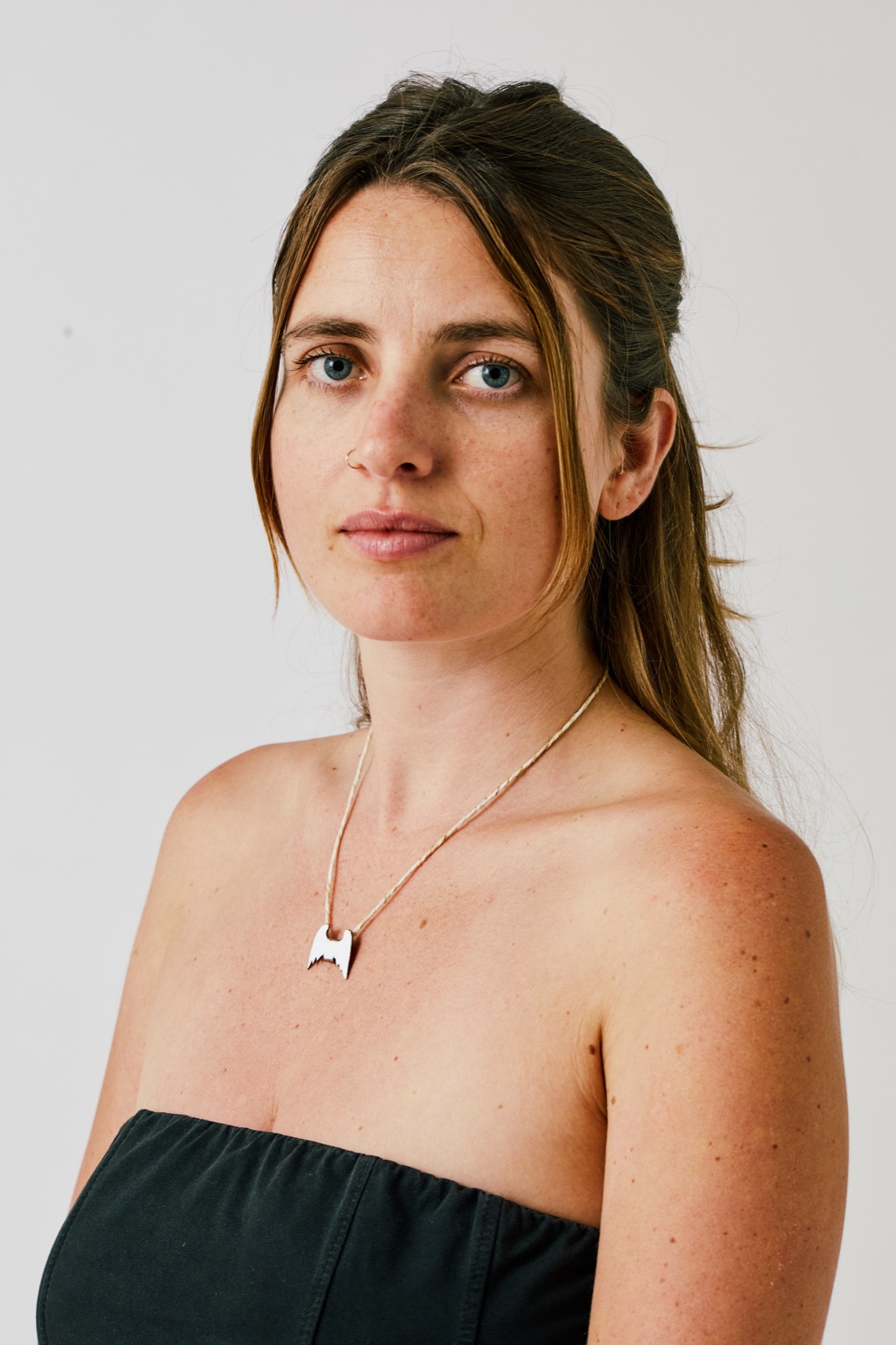 Nehora wearing a silver winged pendant